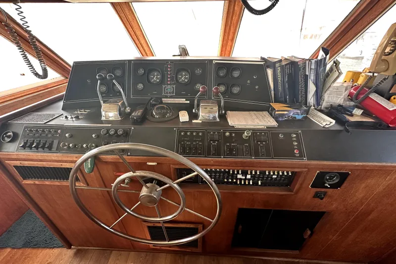 Slide: The Image of 1985 Chris-Craft 500 Constellation helm with vintage controls and navigation instruments. - 3