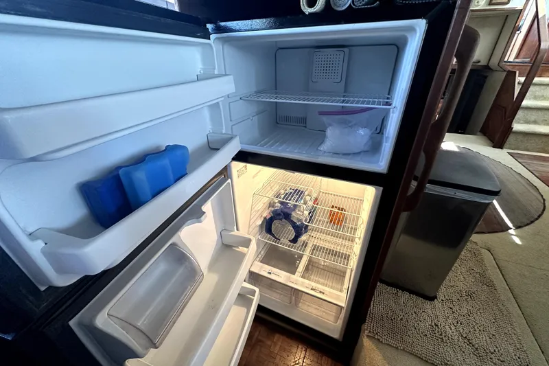 Slide: The Image of Refrigerator interior on 1985 Chris-Craft 500 Constellation yacht, showing freezer and fridge compartments. - 34
