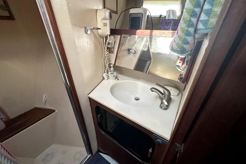 Slide: The Image of 1985 Chris-Craft 500 Constellation bathroom with sink, mirror, and shower area. - 40
