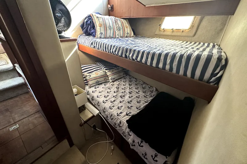Slide: The Image of Bunk beds in 1985 Chris-Craft 500 Constellation yacht cabin with nautical-themed bedding. - 43