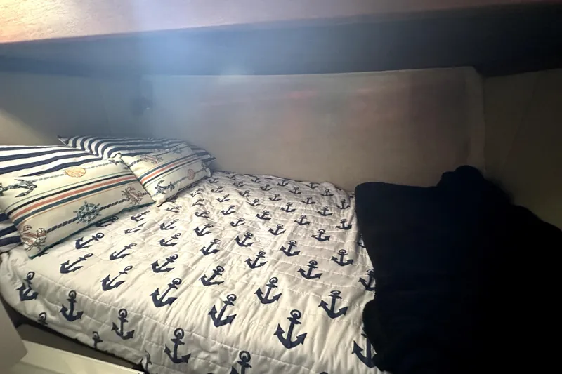 Slide: The Image of Cozy cabin bed with nautical-themed bedding on 1985 Chris-Craft 500 Constellation yacht. - 46