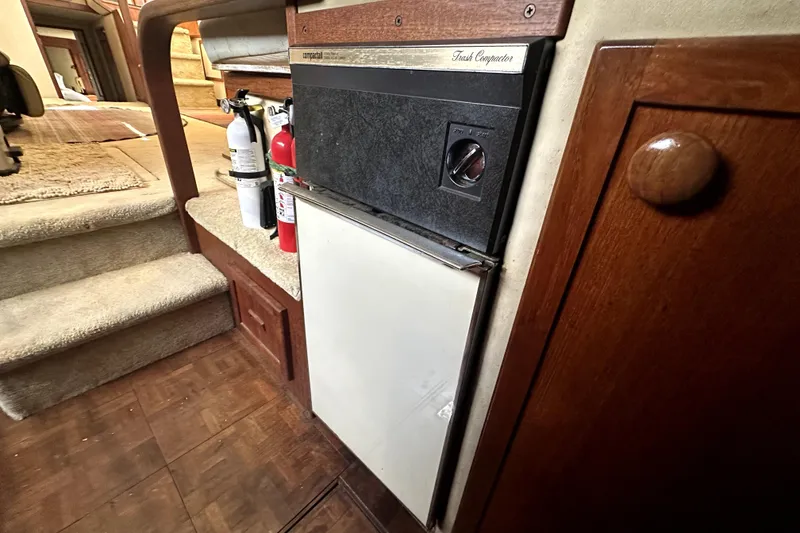 Slide: The Image of 1985 Chris-Craft 500 Constellation interior with trash compactor and fire extinguishers. - 49