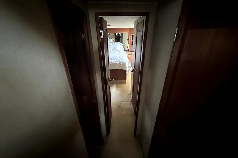 Slide: The Image of Narrow hallway leading to a cozy bedroom on a 1985 Chris-Craft 500 Constellation yacht. - 50