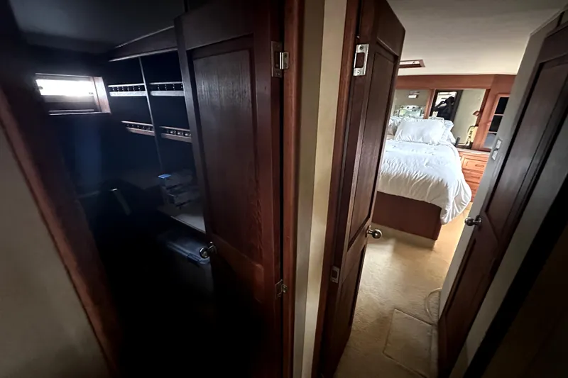 Slide: The Image of Interior of 1985 Chris-Craft 500 Constellation yacht with bedroom and storage area. - 53