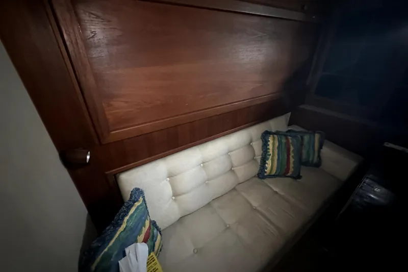 Slide: The Image of Interior of 1985 Chris-Craft 500 Constellation with cushioned seating and decorative pillows. - 54