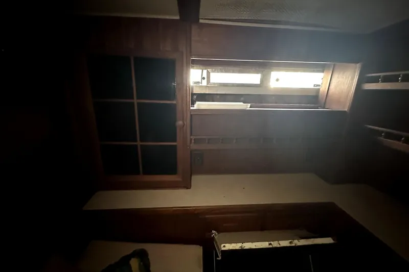 Slide: The Image of Interior of 1985 Chris-Craft 500 Constellation yacht with wooden cabinetry and window. - 57