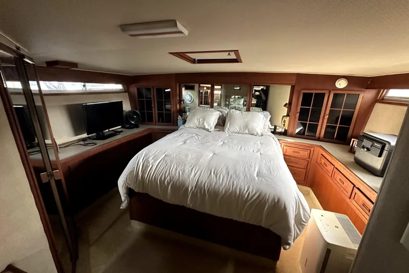 Slide: The Image of Luxurious bedroom interior of 1985 Chris-Craft 500 Constellation yacht with wood cabinetry and modern amenities. - 60