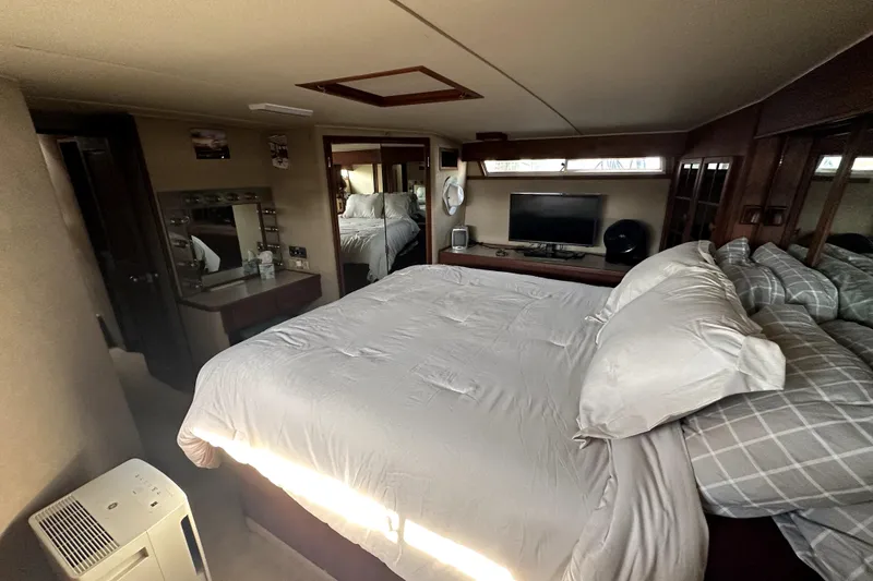 Slide: The Image of Luxurious bedroom interior of 1985 Chris-Craft 500 Constellation yacht with cozy bedding and TV. - 62