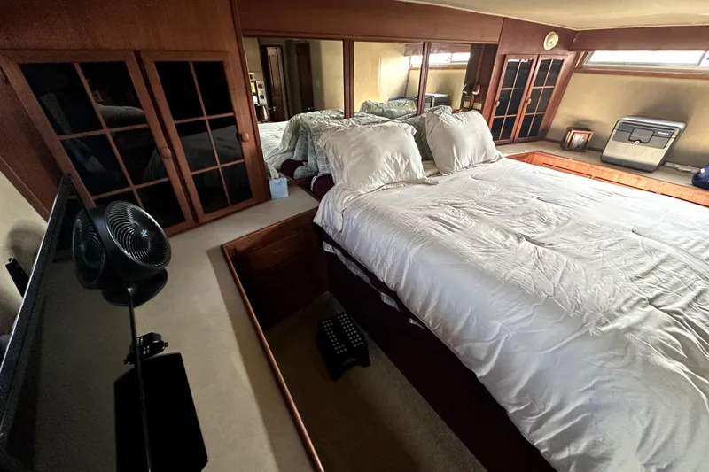 Slide: The Image of Luxurious bedroom interior of 1985 Chris-Craft 500 Constellation yacht with elegant wood finishes. - 66