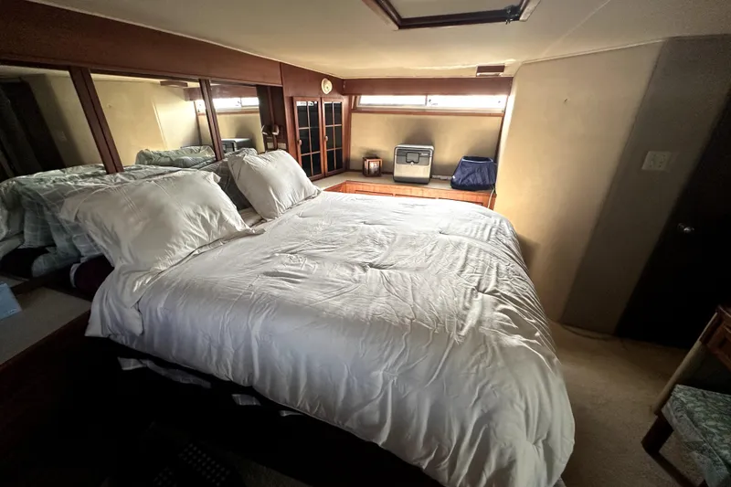 Slide: The Image of Luxurious bedroom interior of 1985 Chris-Craft 500 Constellation yacht with cozy bedding. - 67