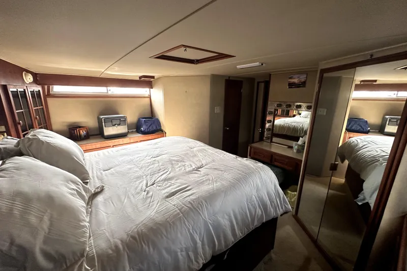 Slide: The Image of Luxurious bedroom interior of 1985 Chris-Craft 500 Constellation yacht with cozy bedding. - 68