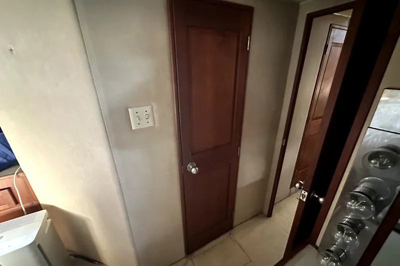 Slide: The Image of Interior hallway of 1985 Chris-Craft 500 Constellation yacht with wooden doors and light switch. - 69