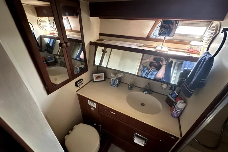 Slide: The Image of Bathroom interior of 1985 Chris-Craft 500 Constellation yacht, featuring sink and mirror. - 70
