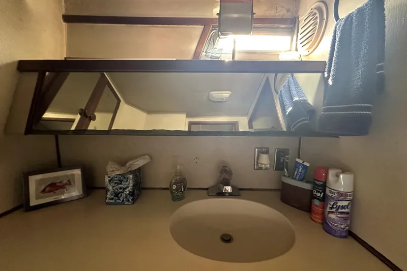 Slide: The Image of 1985 Chris-Craft 500 Constellation bathroom with mirror, sink, and toiletries. - 71