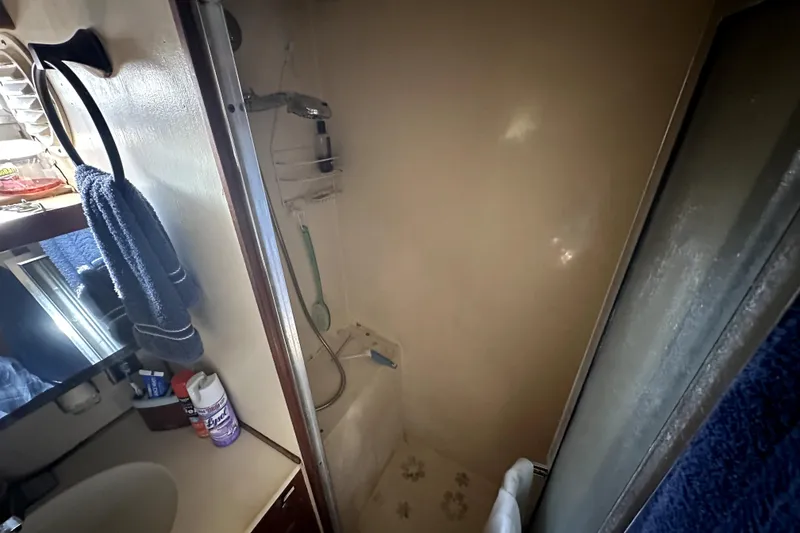 Slide: The Image of 1985 Chris-Craft 500 Constellation bathroom with shower, sink, and toiletries. - 73