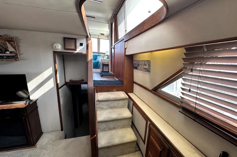 Slide: The Image of Interior of 1985 Chris-Craft 500 Constellation yacht with stairs and cozy seating area. - 74
