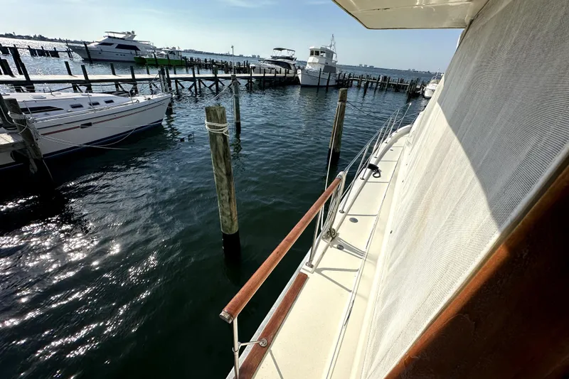 Slide: The Image of 1985 Chris-Craft 500 Constellation yacht docked at marina, sunny day, calm waters. - 78