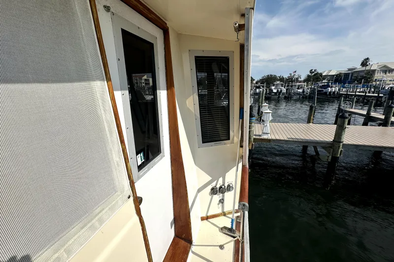 Slide: The Image of 1985 Chris-Craft 500 Constellation yacht docked at marina, showcasing exterior details. - 79