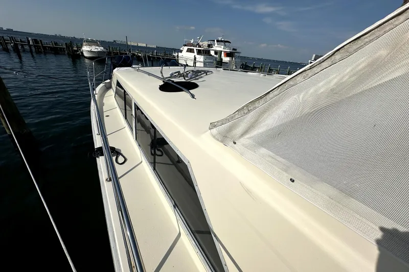 Slide: The Image of 1985 Chris-Craft 500 Constellation yacht docked at marina under clear blue sky. - 80