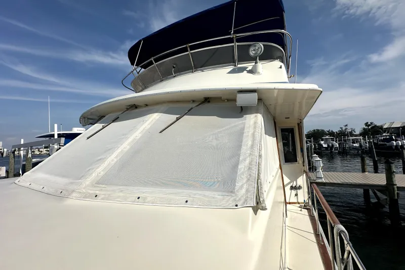 Slide: The Image of 1985 Chris-Craft 500 Constellation yacht docked at marina under clear sky. - 81