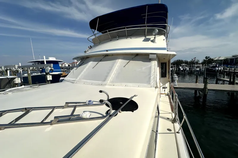Slide: The Image of 1985 Chris-Craft 500 Constellation yacht docked at marina under clear sky. - 83