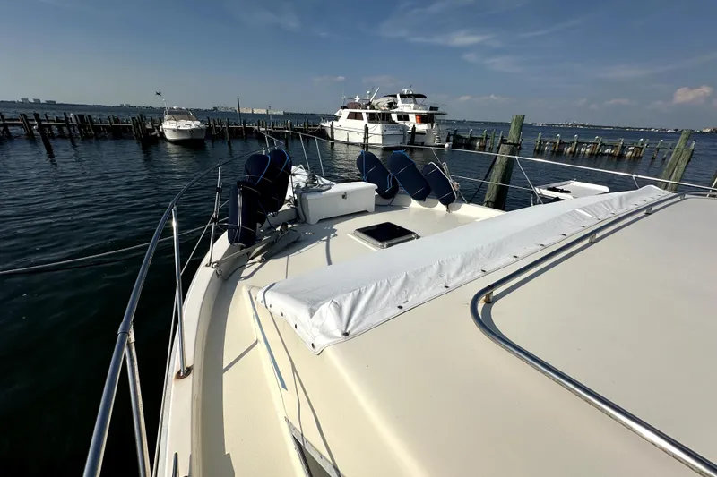 Slide: The Image of 1985 Chris-Craft 500 Constellation yacht docked at marina under clear sky. - 84