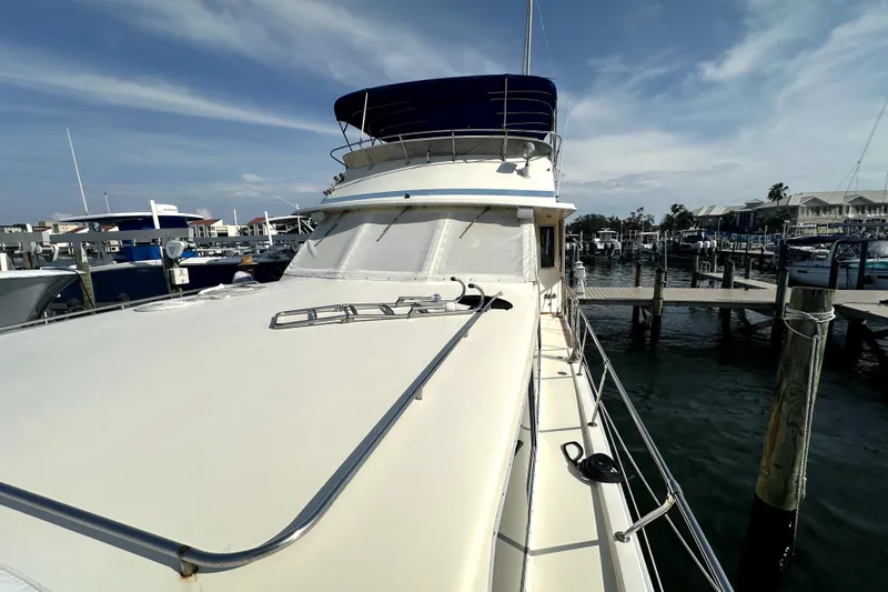 Slide: The Image of 1985 Chris-Craft 500 Constellation yacht docked at marina under clear sky. - 85