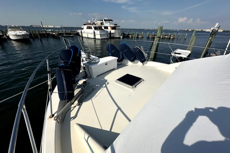 Slide: The Image of 1985 Chris-Craft 500 Constellation yacht docked at marina, sunny day, clear sky. - 86
