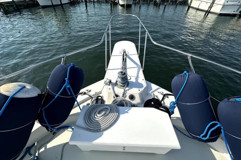 Slide: The Image of Bow view of 1985 Chris-Craft 500 Constellation with fenders and ropes in a marina. - 91