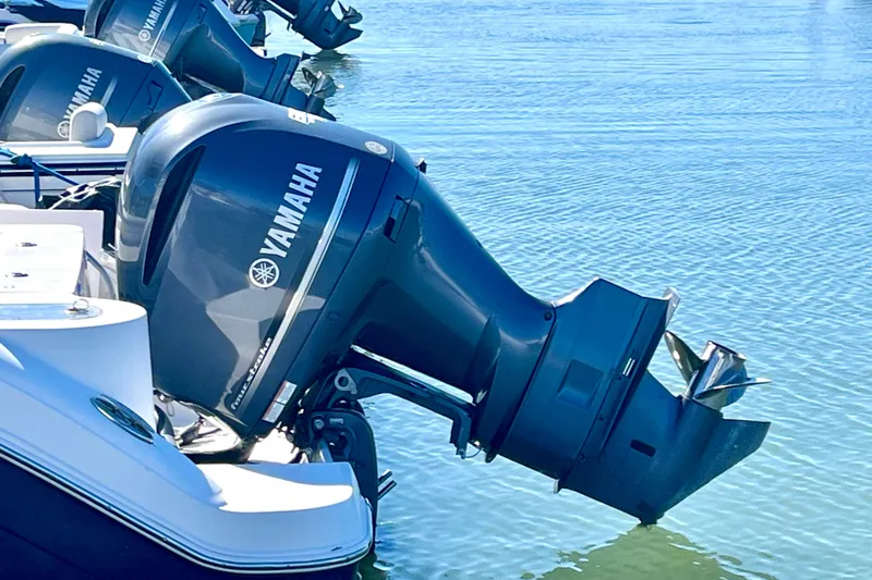 Slide: The Image of 2014 Robalo R247 Dual Console with Yamaha outboard engines on water. - 13