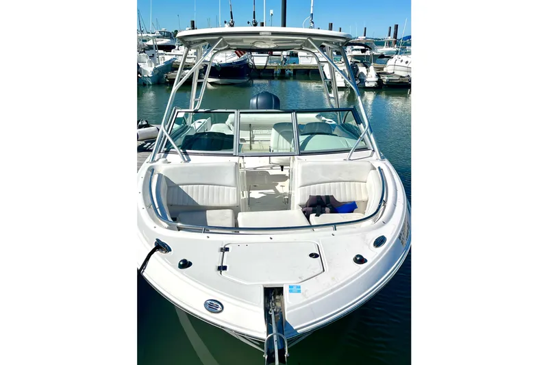 Slide: The Image of 2014 Robalo R247 Dual Console boat docked in marina, front view. - 14