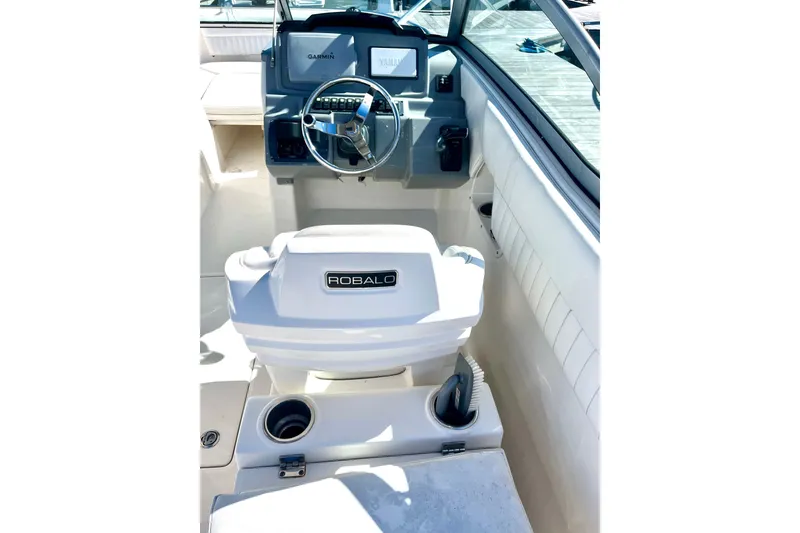 Slide: The Image of 2014 Robalo R247 Dual Console boat interior with steering wheel and dashboard. - 6