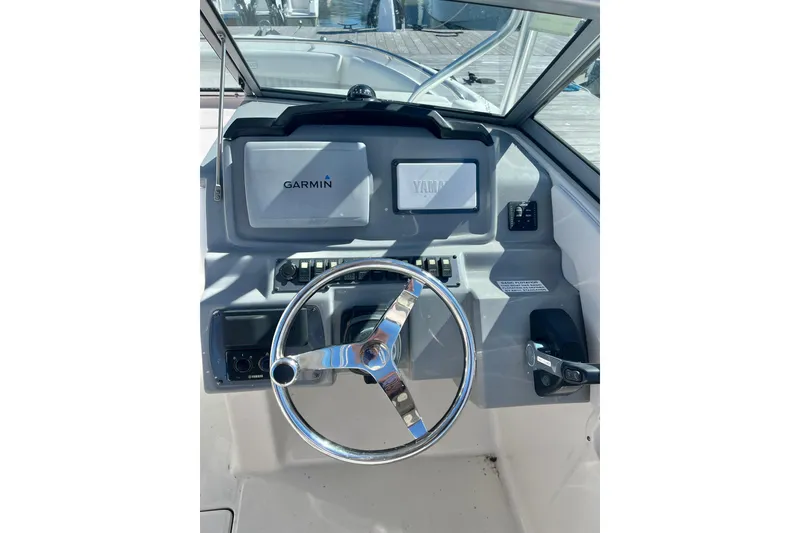 Slide: The Image of 2014 Robalo R247 Dual Console boat dashboard with Garmin and Yamaha controls. - 7