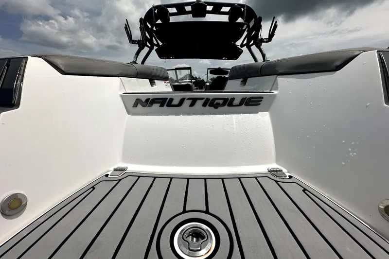 Slide: The Image of 2016 Nautique Super Air Nautique G25 Coastal Edition boat interior, featuring sleek seating and deck design. - 15