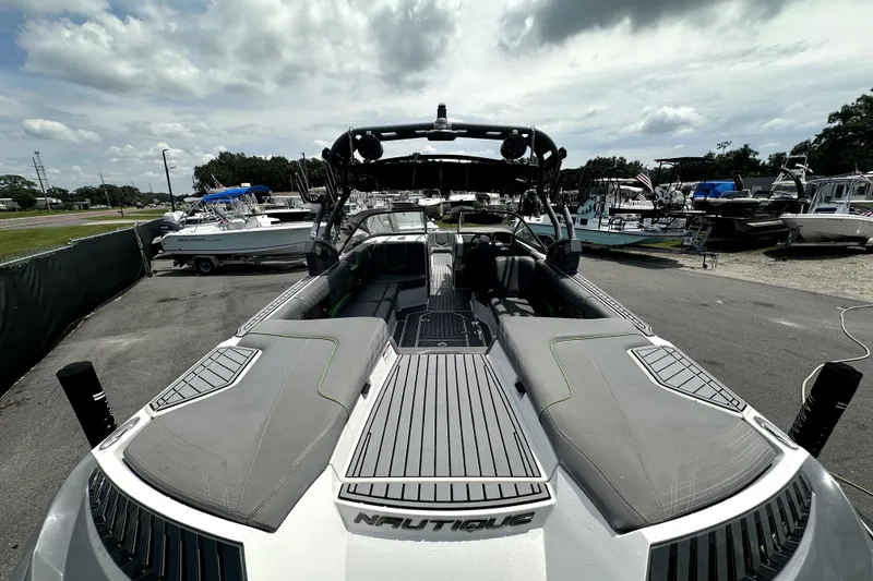 Slide: The Image of 2016 Nautique Super Air Nautique G25 Coastal Edition boat at a marina under cloudy skies. - 17