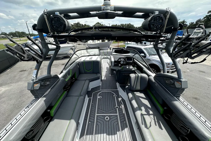 Slide: The Image of 2016 Nautique Super Air Nautique G25 Coastal Edition interior with gray and green seating. - 21