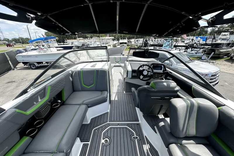 Slide: The Image of 2016 Nautique Super Air Nautique G25 Coastal Edition interior with gray and green seating. - 24