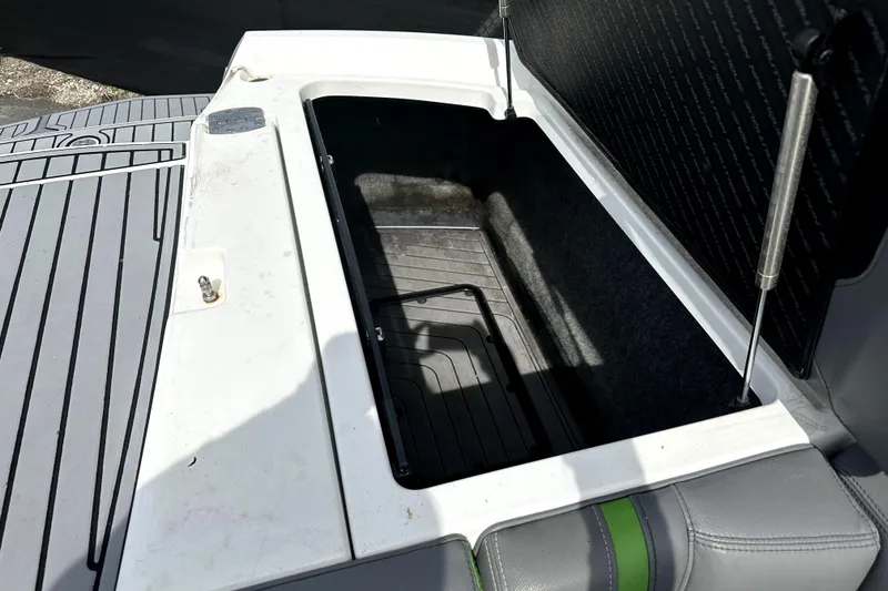 Slide: The Image of 2016 Nautique Super Air Nautique G25 Coastal Edition interior storage compartment open. - 33