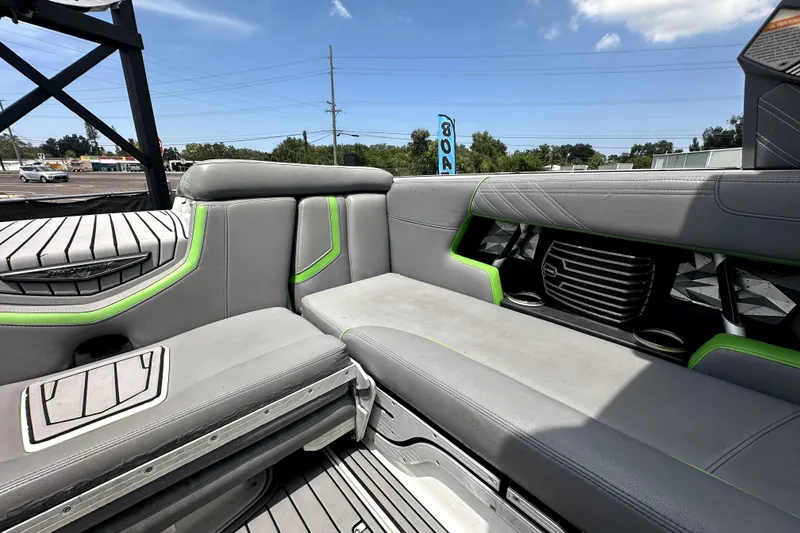 Slide: The Image of 2016 Nautique Super Air Nautique G25 Coastal Edition interior with gray seating and green accents. - 35