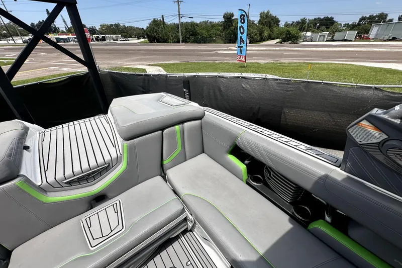 Slide: The Image of 2016 Nautique Super Air Nautique G25 Coastal Edition interior, surrounded by boats and a truck. - 36