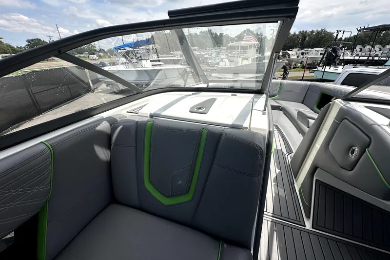 Slide: The Image of 2016 Nautique Super Air Nautique G25 Coastal Edition interior with gray and green seating. - 41