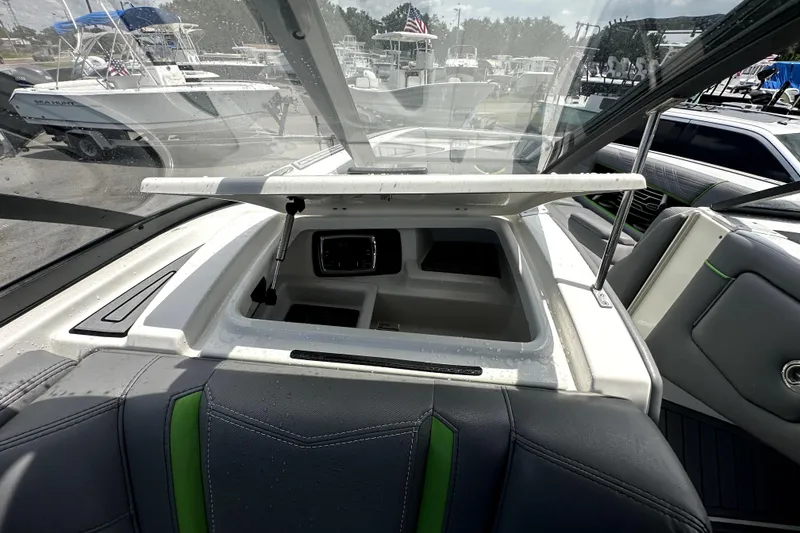 Slide: The Image of 2016 Nautique Super Air Nautique G25 Coastal Edition interior with gray and green seating. - 42