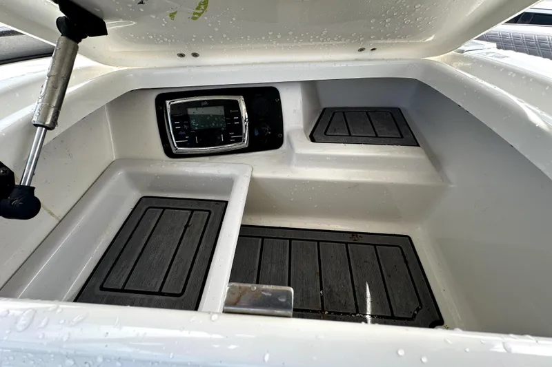 Slide: The Image of 2016 Nautique Super Air Nautique G25 Coastal Edition interior seating with gray and green accents. - 43