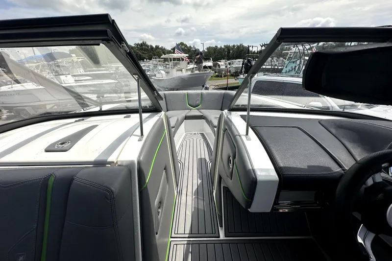 Slide: The Image of 2016 Nautique Super Air Nautique G25 Coastal Edition interior with gray and green seating. - 44