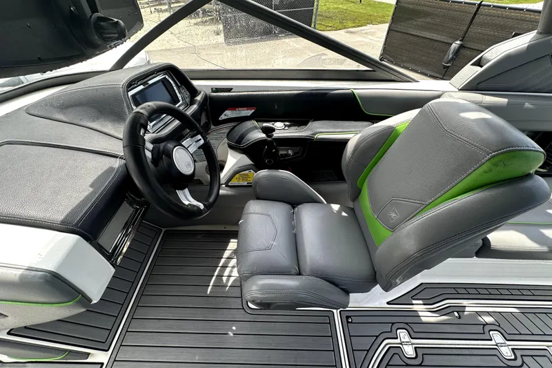 Slide: The Image of 2016 Nautique Super Air Nautique G25 Coastal Edition interior with gray and green seating. - 45