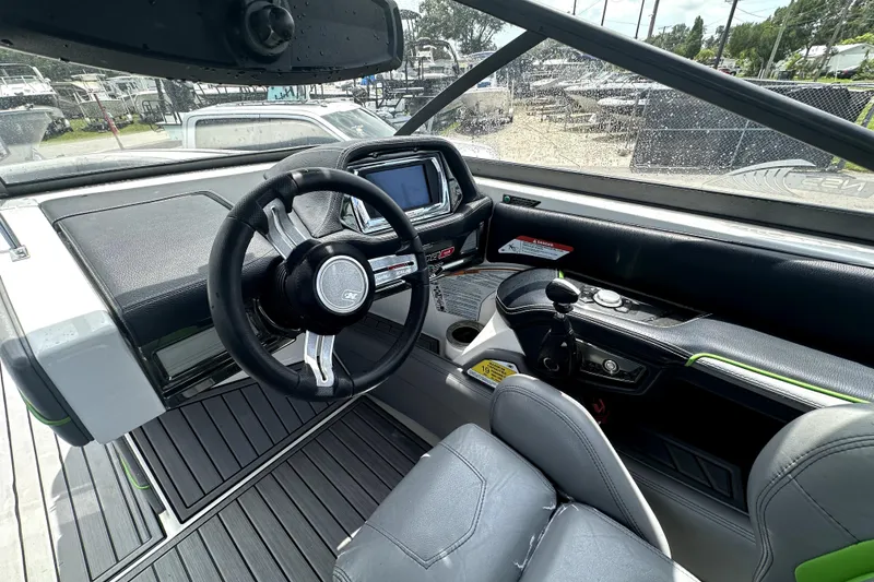 Slide: The Image of Interior of 2016 Nautique Super Air Nautique G25 Coastal Edition boat, featuring sleek seating and controls. - 47