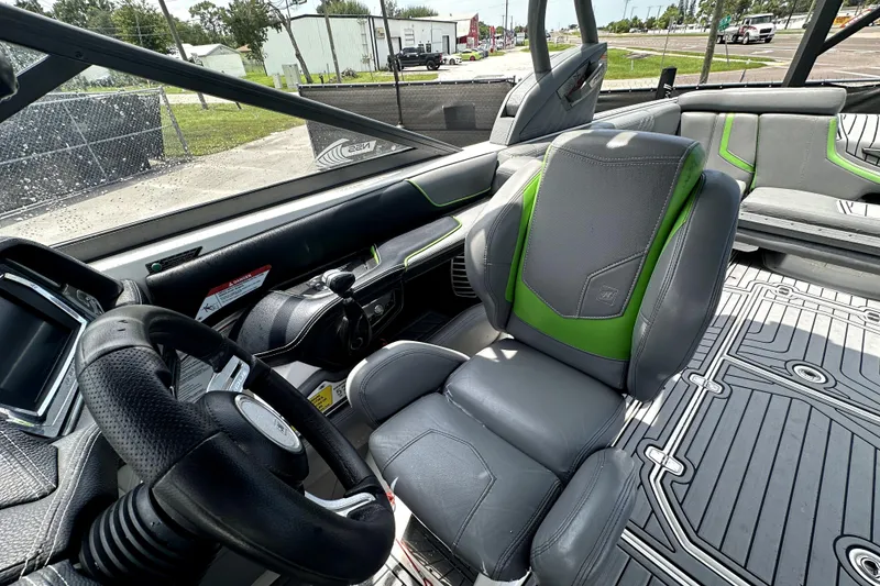 Slide: The Image of 2016 Nautique Super Air Nautique G25 Coastal Edition interior with gray and green seating. - 48