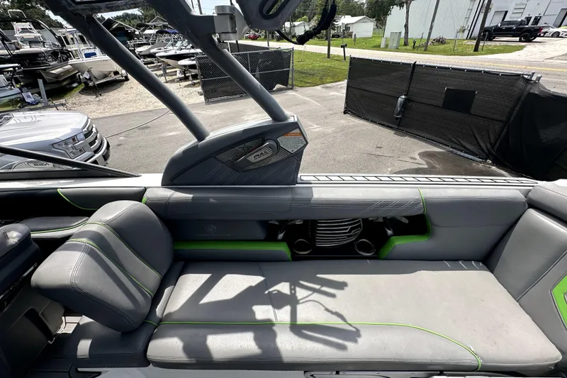 Slide: The Image of 2016 Nautique Super Air Nautique G25 Coastal Edition interior with gray and green seating. - 49