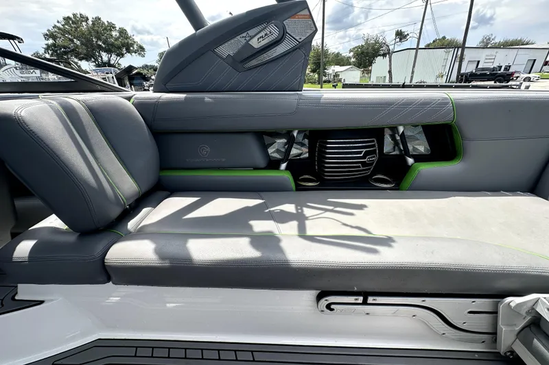 Slide: The Image of 2016 Nautique Super Air Nautique G25 Coastal Edition interior with gray and green seating. - 50