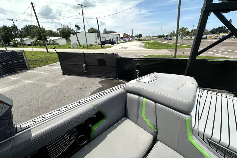 Slide: The Image of 2016 Nautique Super Air Nautique G25 Coastal Edition interior seating with gray and green accents. - 51
